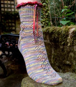 opus200 Opus 200 sock: ribbon-decorated cuff and catherine wheel lace design